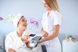 woman paying at medspa as member
